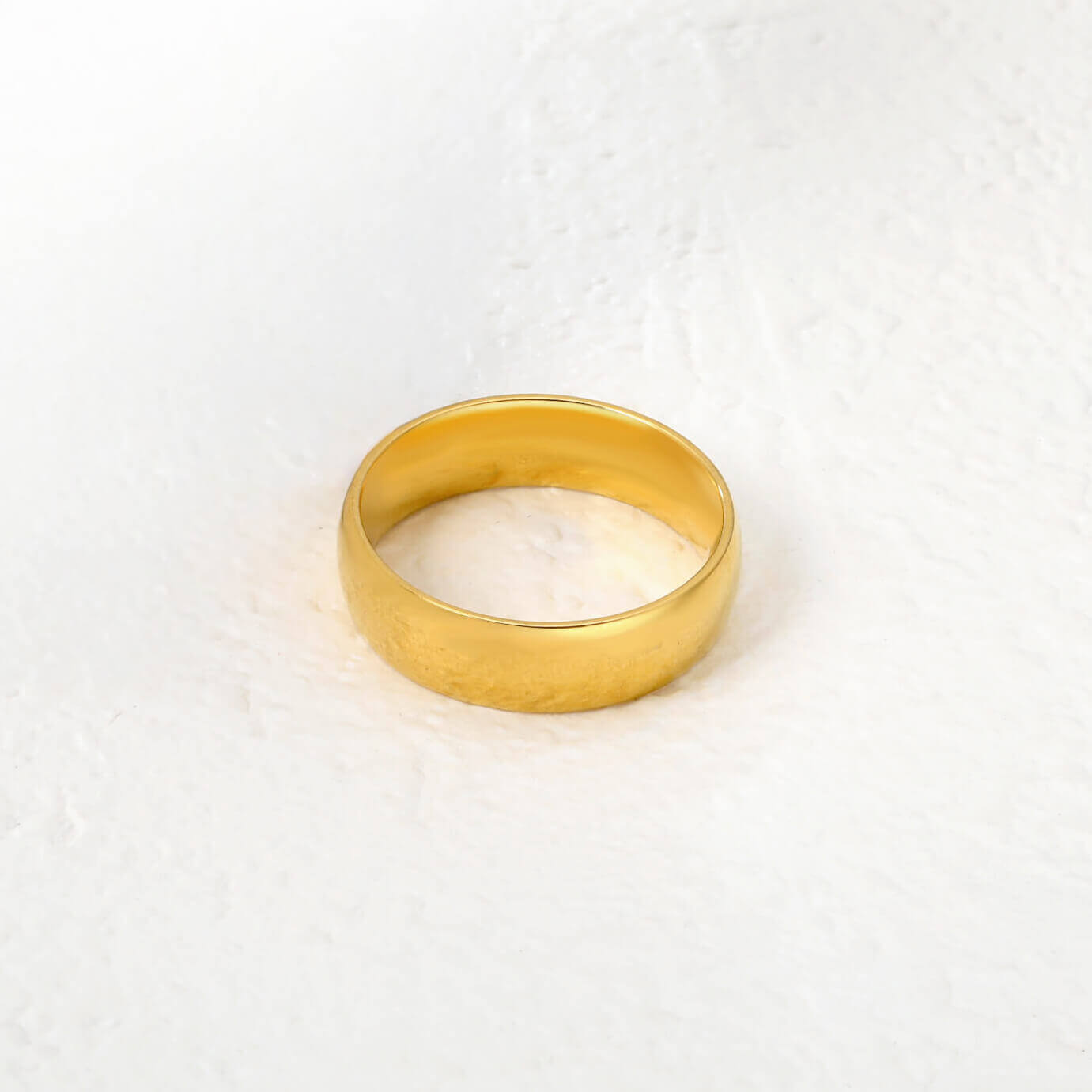 Kullattu vedenkestävä naisten sormus valkoisella taustalla. Ihoystävällinen materiaali. 