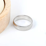 Madoww hopean sävyinen teräs sormus alkoisella taustalla. Minimalistinen design.