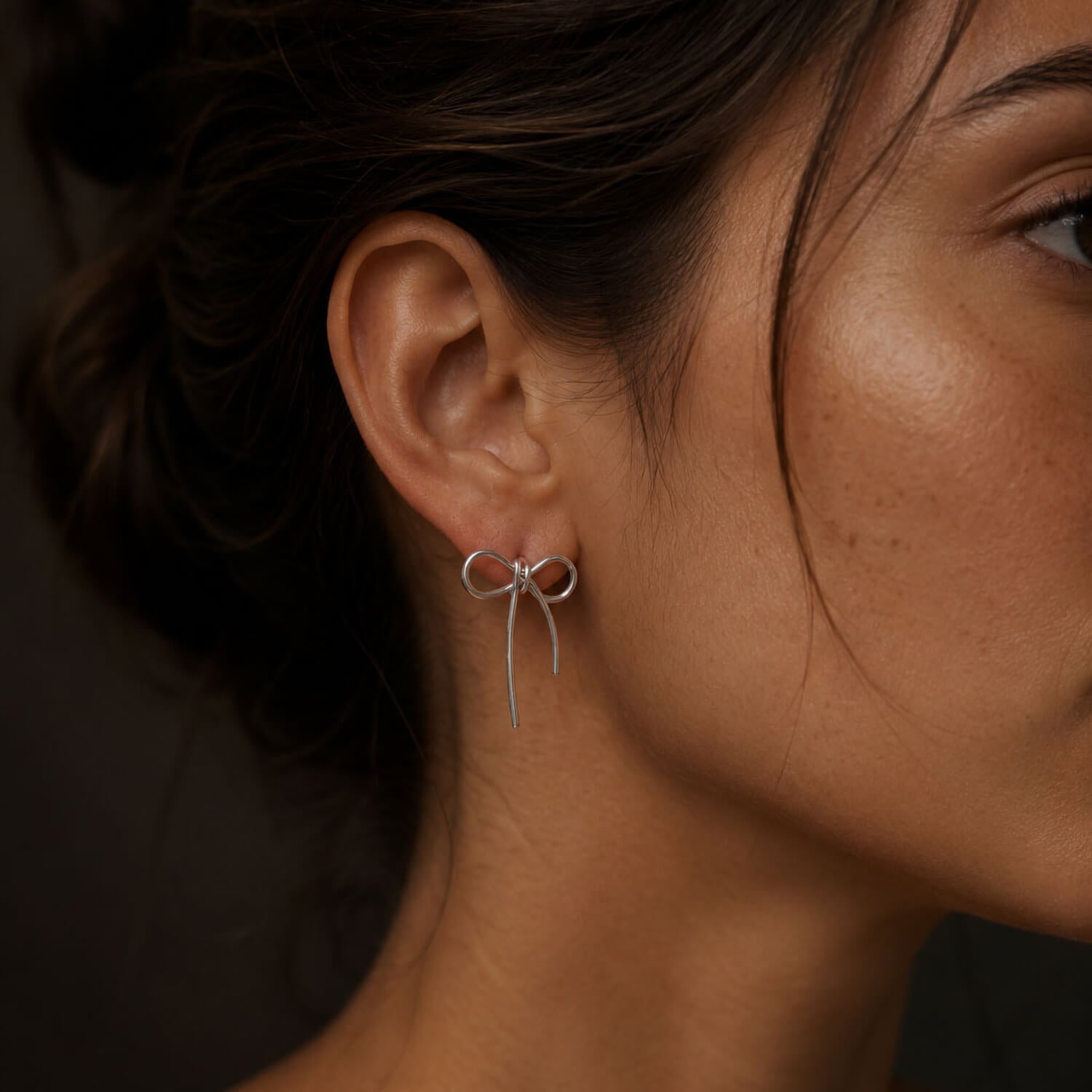 madoww Bow waterproof bow earrings in silver stainless steel worn on ear