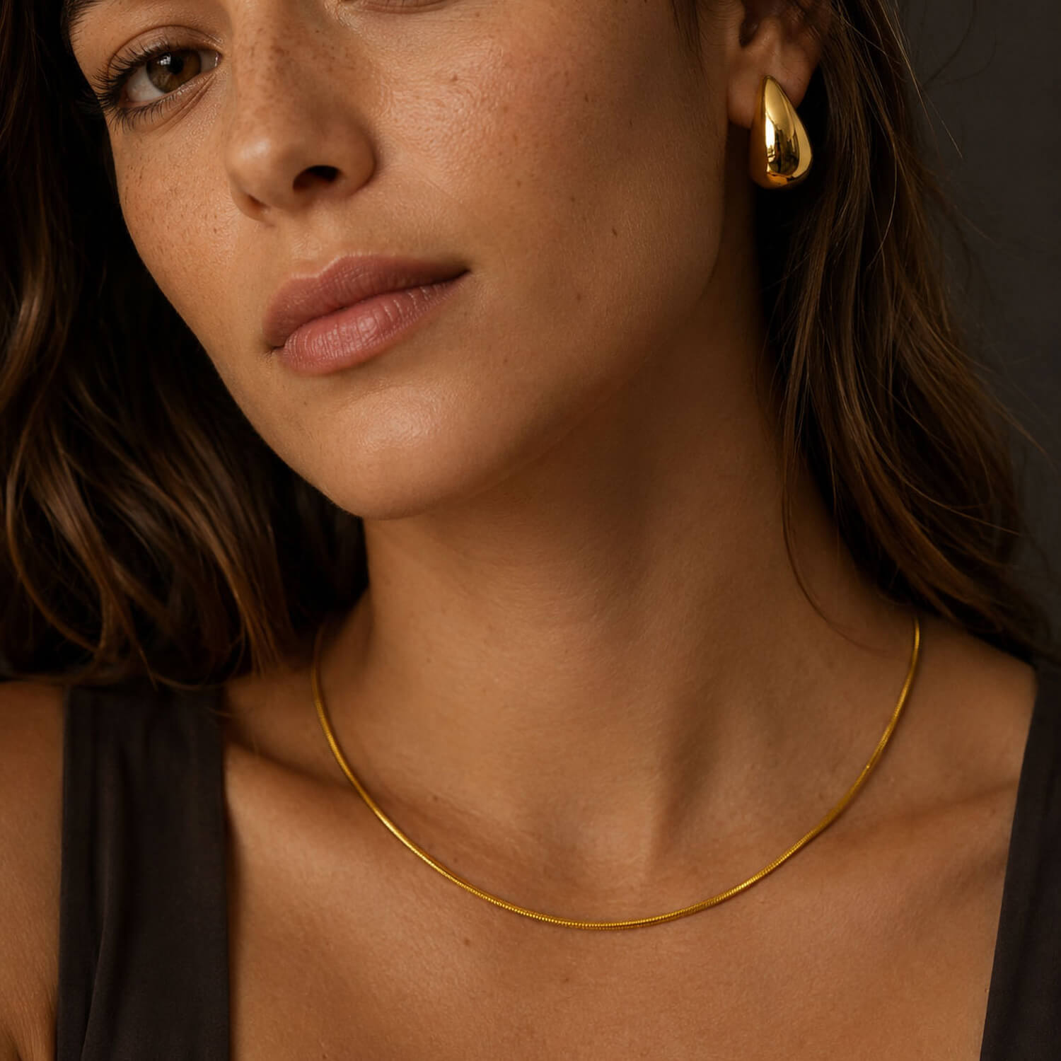 Ivy waterproof necklace in 18K PVD gold plating on a model, a delicate minimalist necklace styled on the neck