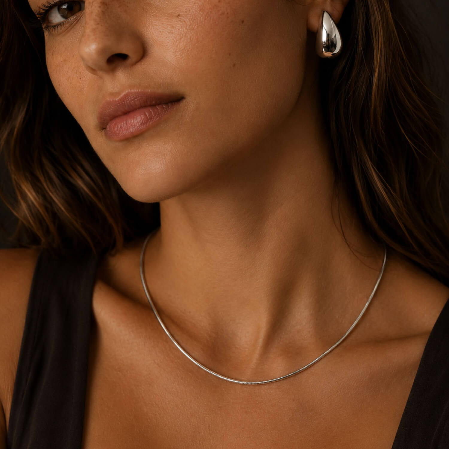 Ivy waterproof necklace in stainless steel on a model, a delicate silver-tone minimalist necklace styled on the neck
