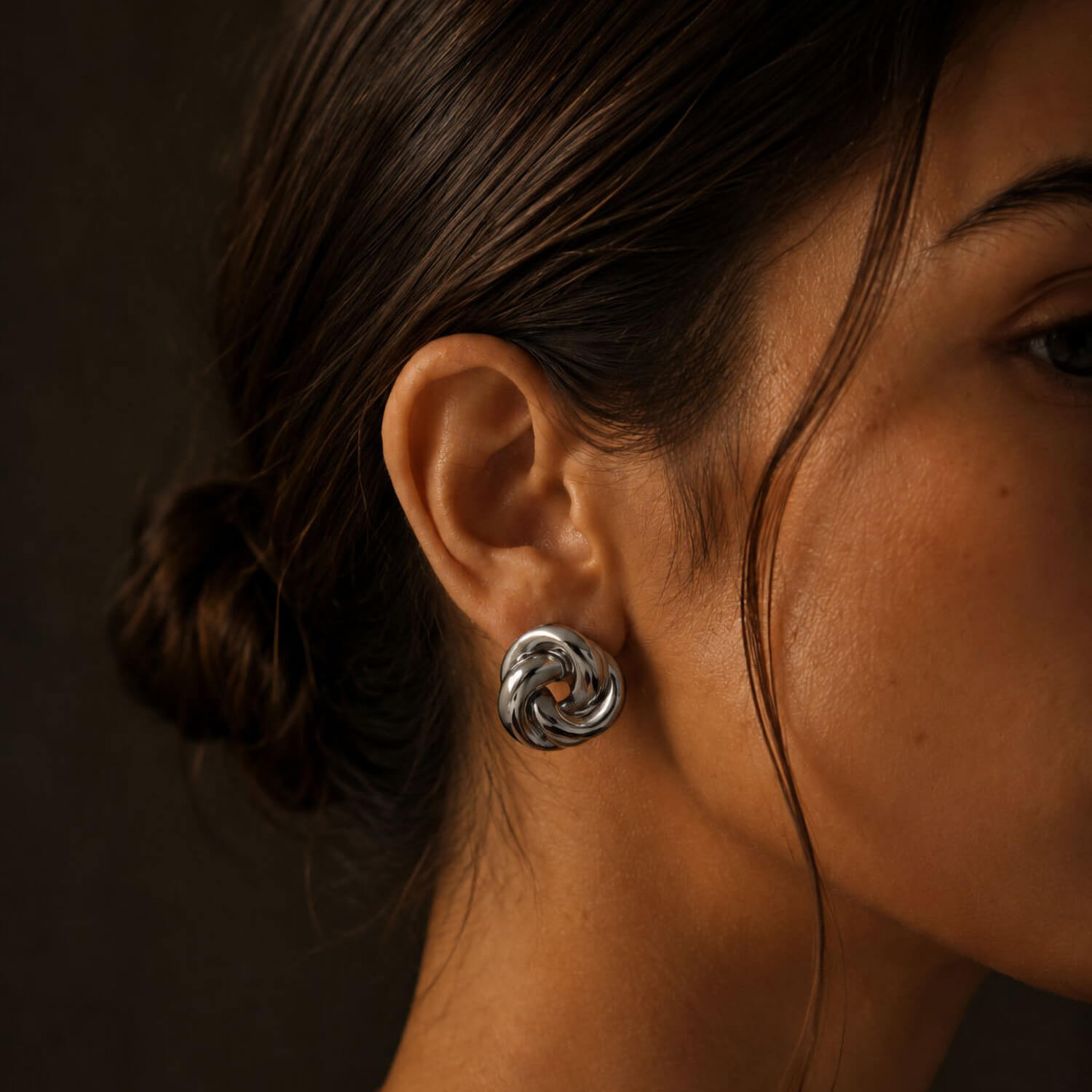 madoww Swirl waterproof earrings in silver skin-friendly stainless steel worn on ear
